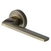 Heritage Brass Door Handle Lever Latch on Round Rose Metro Angled Design Antique Brass finish