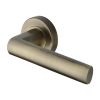 Heritage Brass Door Handle Lever Latch on Round Rose Poseidon Design Antique Brass finish